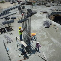 a group of men standing on top of a construction site