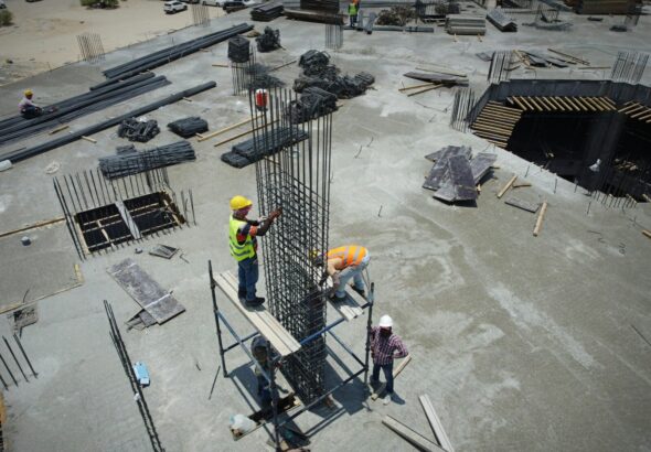 a group of men standing on top of a construction site